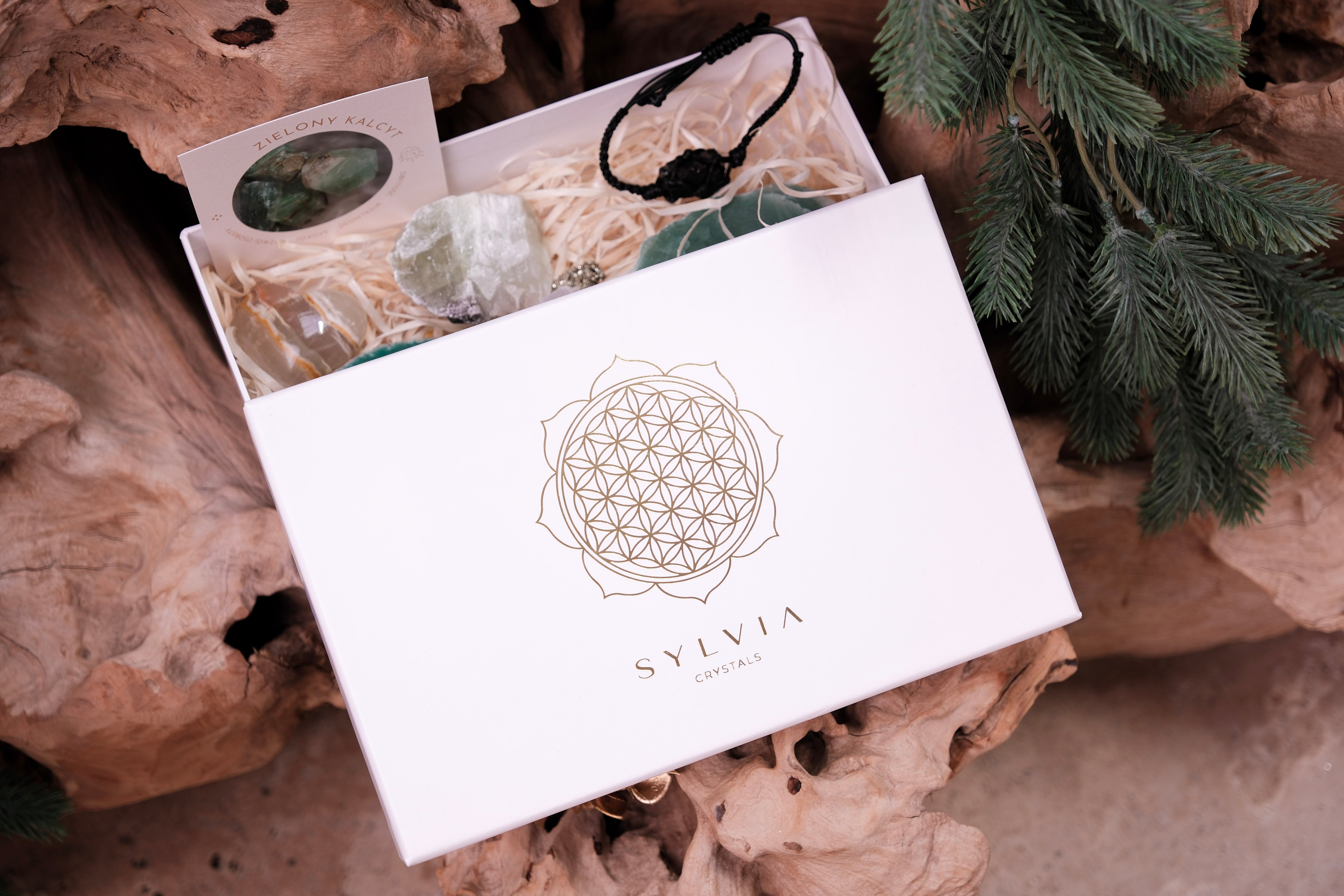 Christmas Crystal Gift Box with wellness treasures, featuring elegant design and festive elements on rustic background.