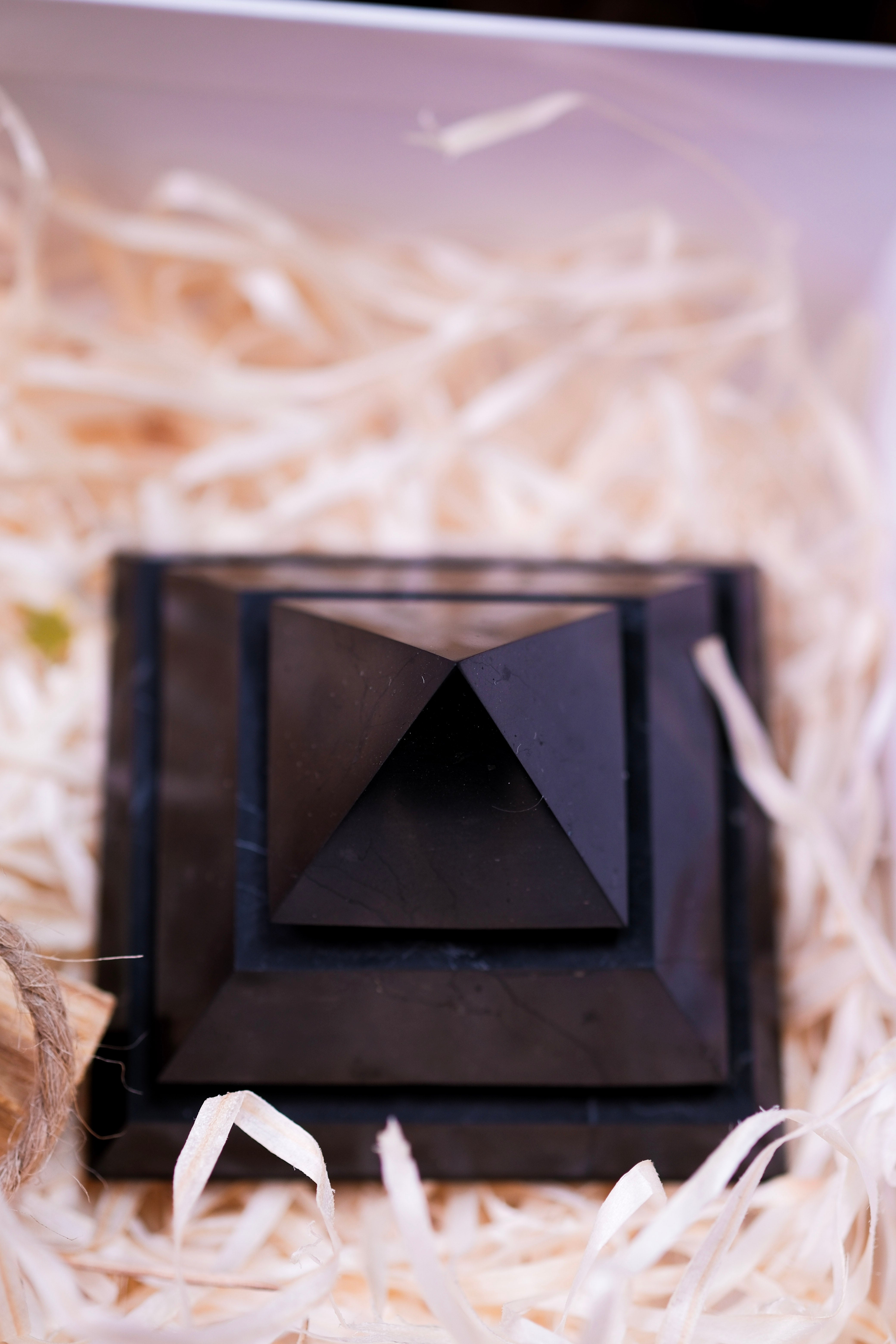 Black Shungite Pyramid in Christmas Luxury Crystal Gift Box on straw bedding