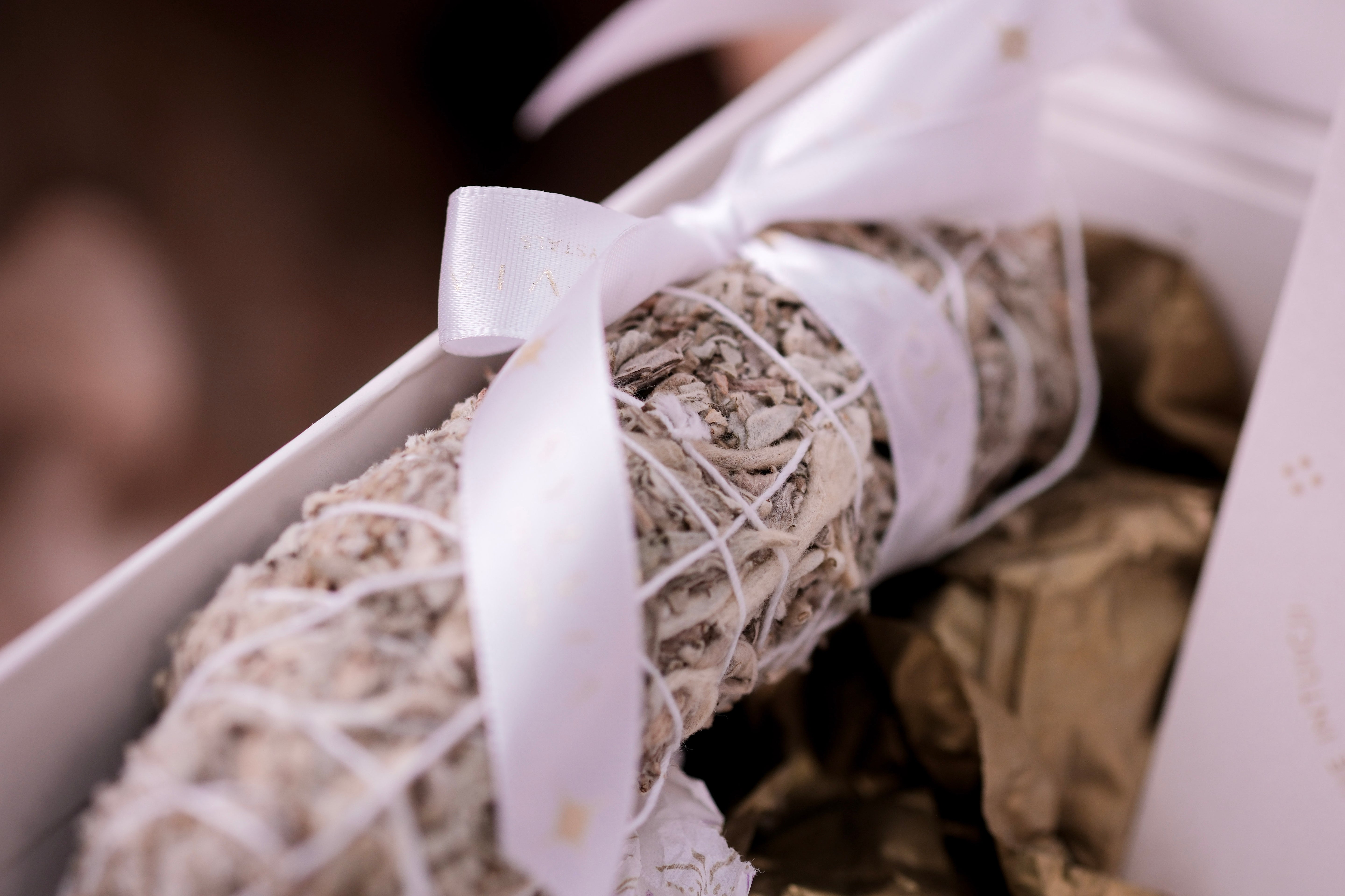 White sage bundle wrapped in ribbon from Transformations Deluxe Christmas Box by Sylvia Crystals for growth and renewal.