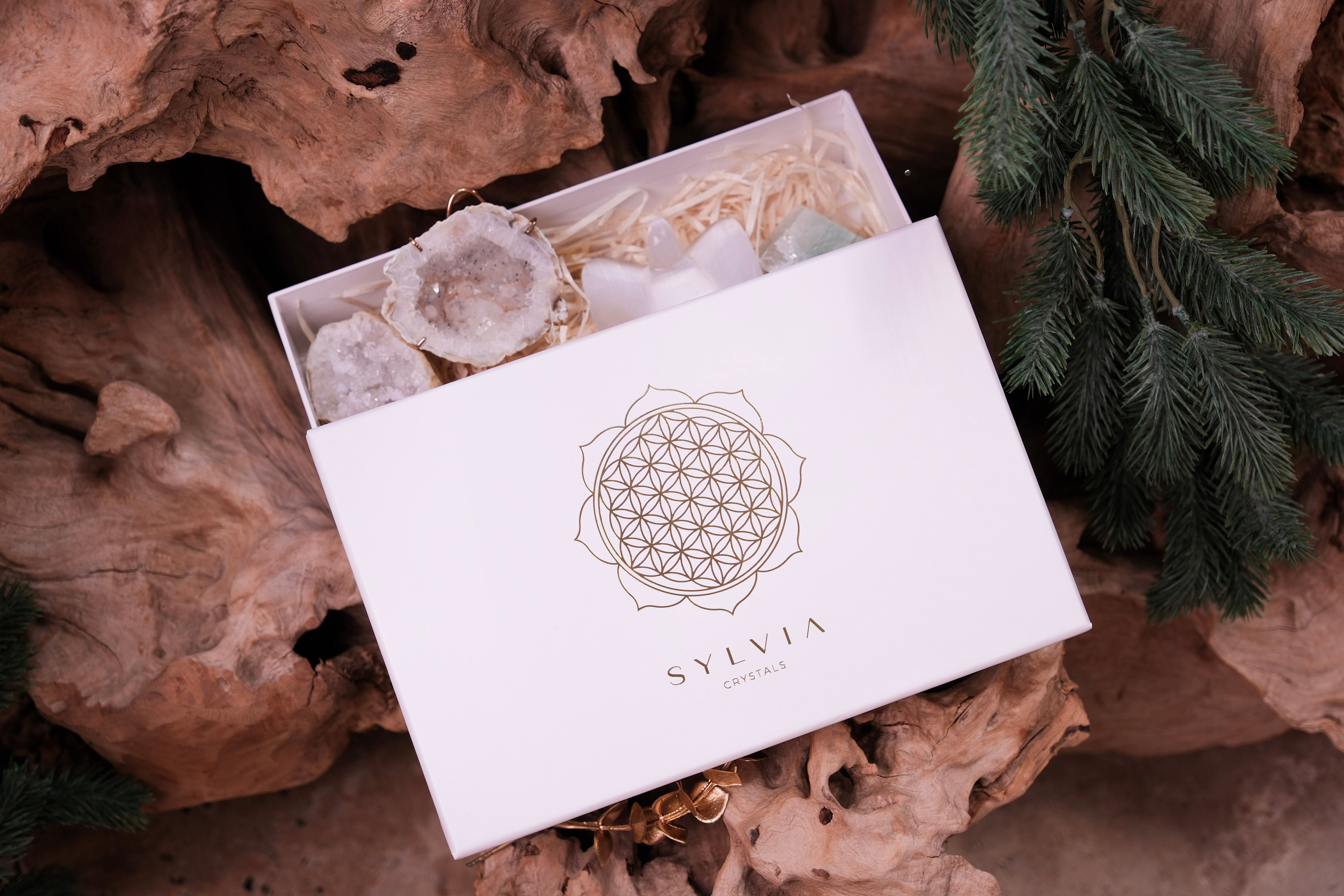 "Angelic Elegance Christmas Gift Box with crystals and jewelry box by Sylvia Crystals, set on a rustic wooden background"