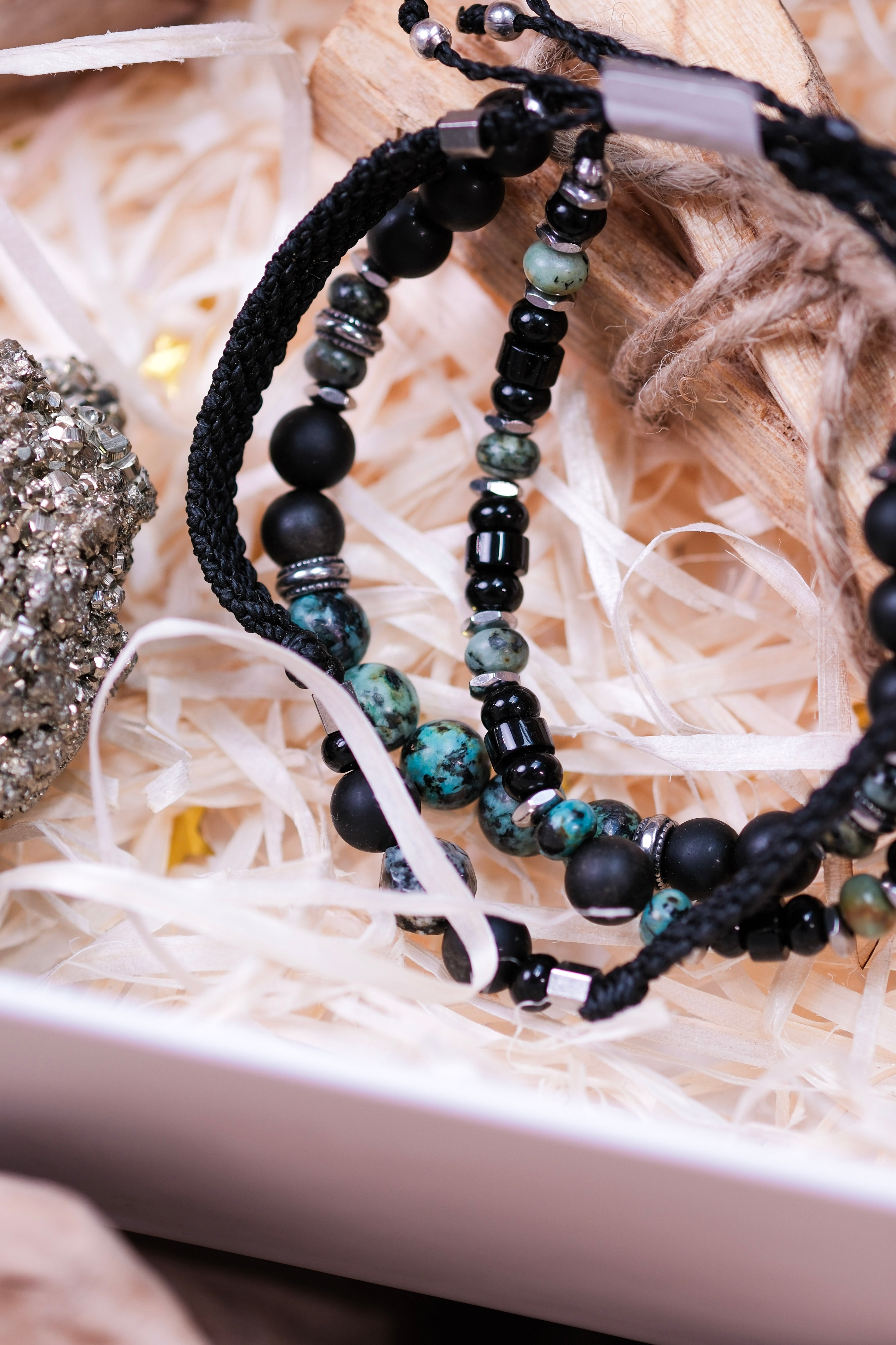 Elegant stone bead bracelets in Christmas Luxury Crystal Gift Box on decorative straw setting.