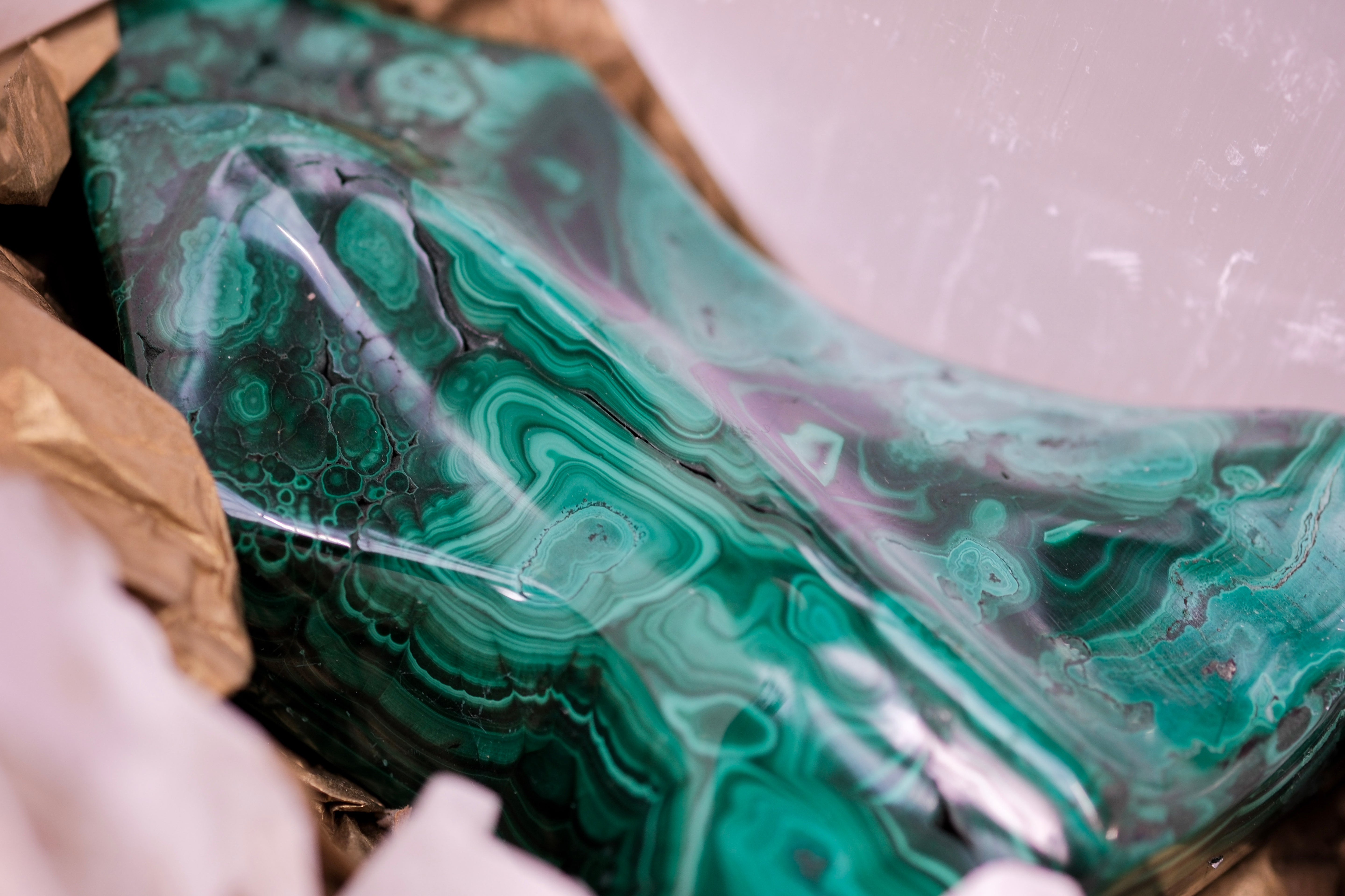 Close-up of a polished malachite stone with vibrant green patterns, part of the Transformations Deluxe Christmas Gift Box by Sylvia Crystals.