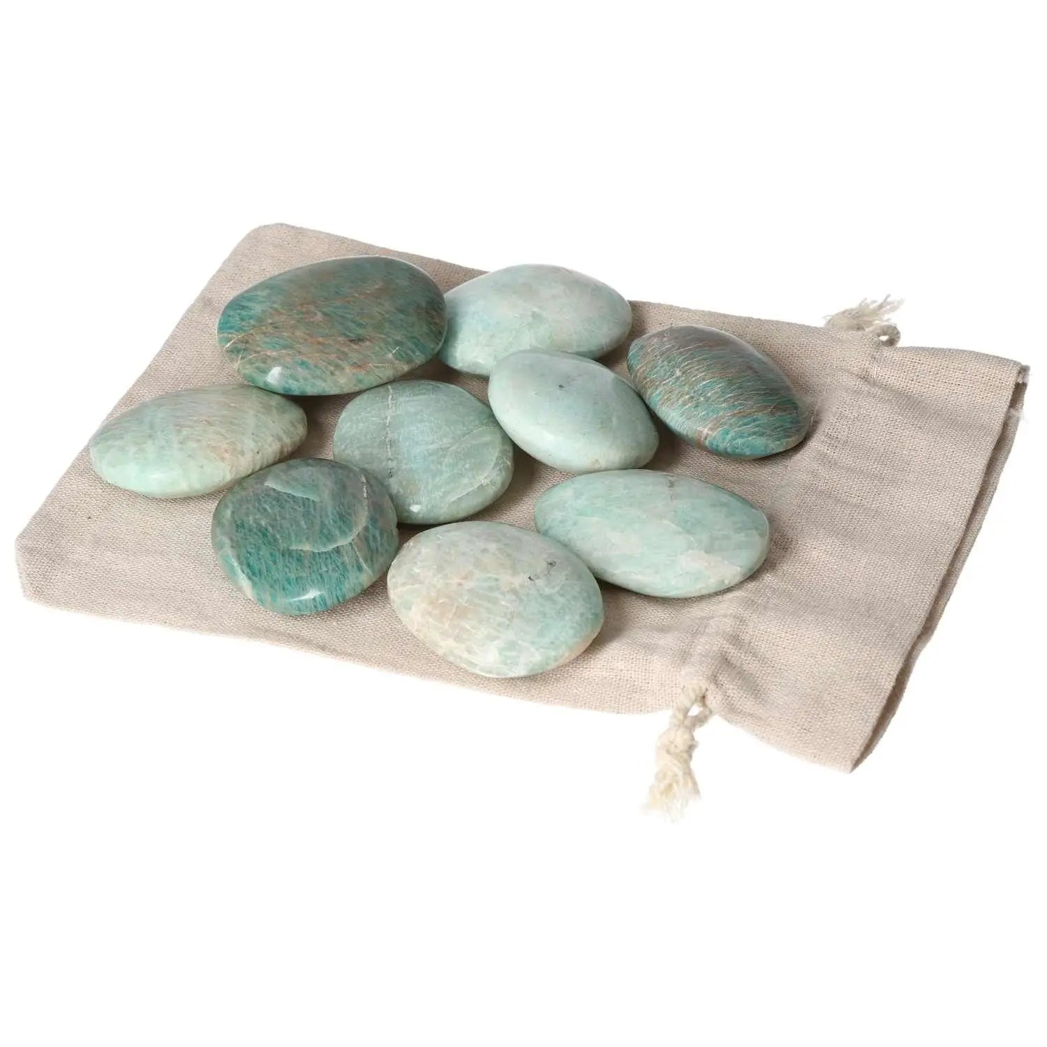 Collection of Amazonite Palm Stones on beige fabric, promoting calming energy and spiritual integration by Sylvia Crystals.