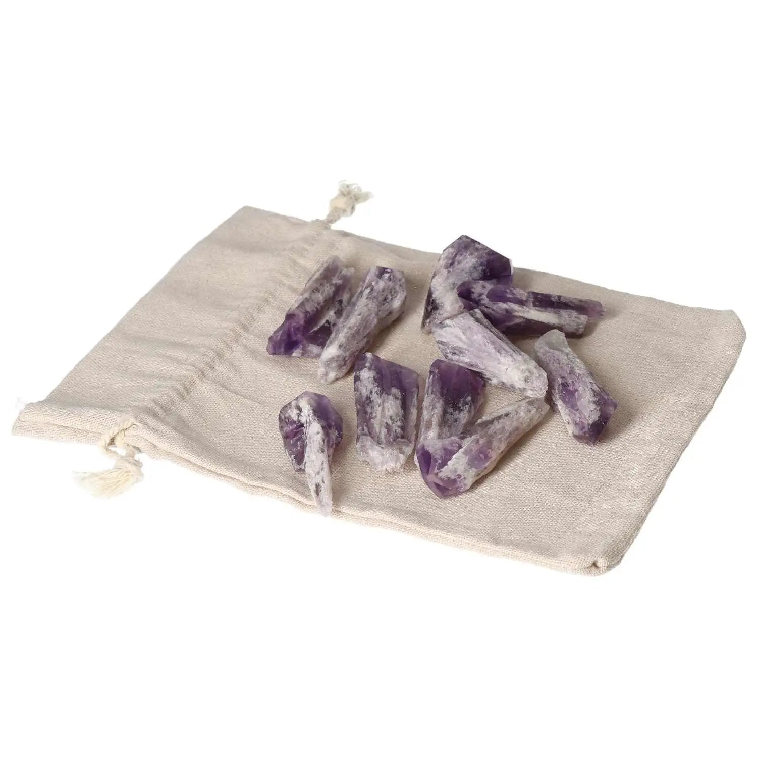 Amethyst Point S crystals from Sylvia Crystals on a beige drawstring pouch, symbolizing serenity, sophistication, and stress reduction.