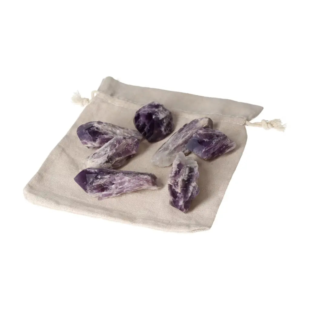 Amethyst Point M crystals on a beige drawstring pouch, showcasing natural elegance and premium quality for stress relief and energy enhancement.