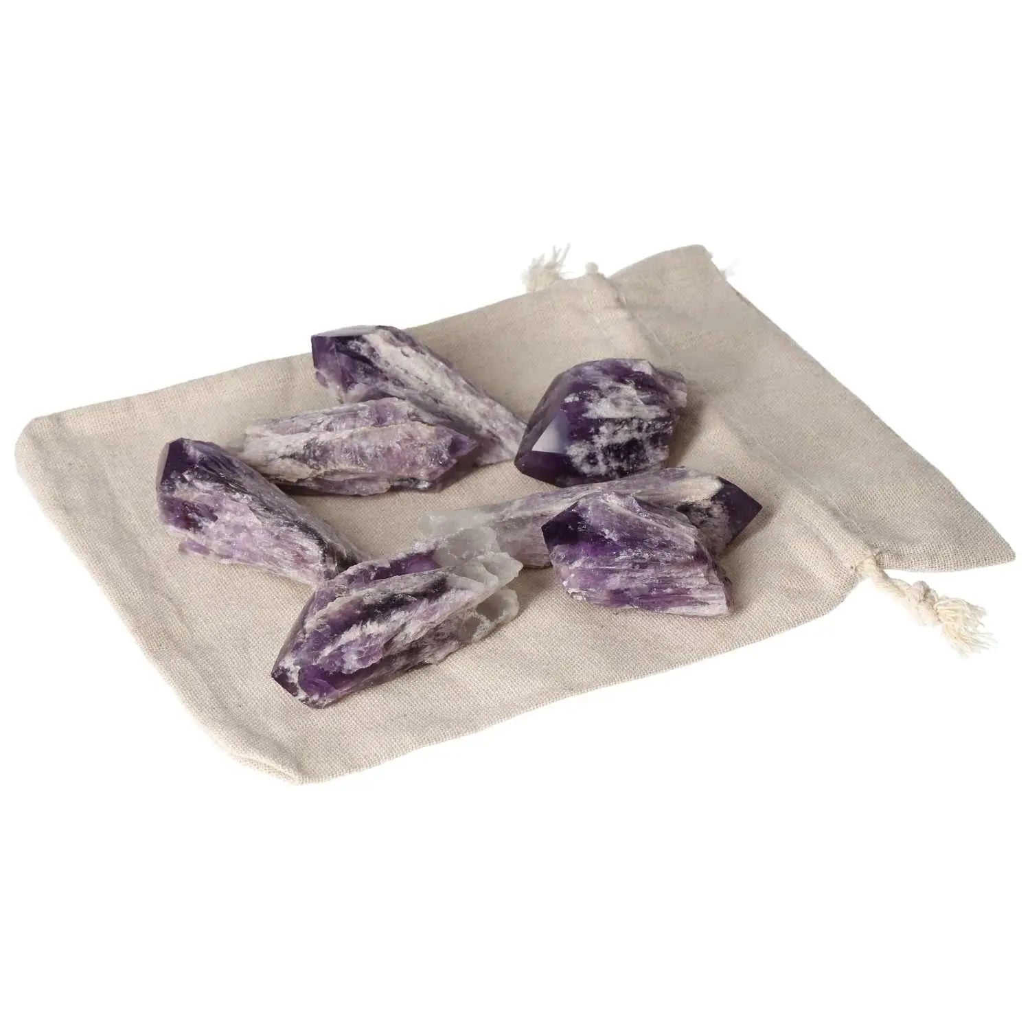 Amethyst Point M crystals on a beige cloth, showcasing premium quality from Sylvia Crystals, known for stress reduction and enhanced energy levels.