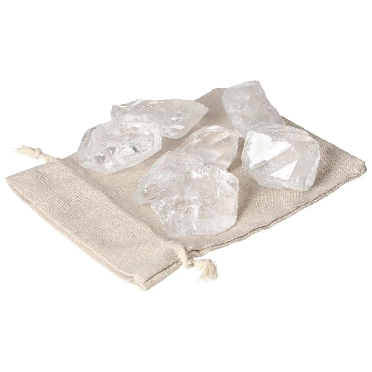 Five Quartz Clear crystals on a beige fabric pouch, showcasing their elegance and purity, ideal for spiritual harmony and balance.