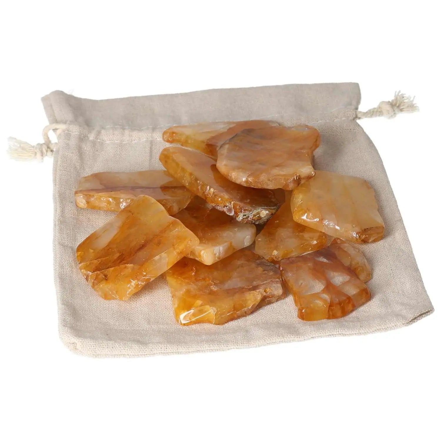 Hematoide Yellow Slice crystals displayed in a beige pouch, showcasing their unique color and texture, enhancing spiritual harmony.