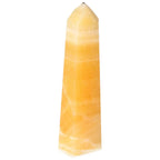 Mexican Calcite Obelisk from Sylvia Crystals, a premium decorative piece known for boosting self-confidence and motivation.