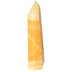 Mexican Calcite Obelisk from Sylvia Crystals, handpicked for conscious luxury and spiritual elegance, boosts confidence and motivation.
