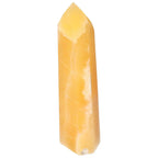 Mexican Calcite Obelisk from Sylvia Crystals, enhancing self-confidence and goal achievement with positive vibrations.