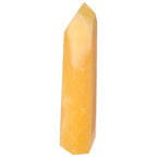 Mexican Calcite Obelisk from Sylvia Crystals, enhances self-confidence, goal achievement, and emits positive vibrations.