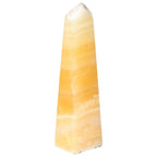 Mexican Calcite Obelisk from Sylvia Crystals, a premium decor piece known for enhancing self-confidence and motivation.