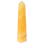 Mexican Calcite Obelisk by Sylvia Crystals, symbolizing transformation and growth, perfect for crystal enthusiasts.