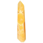 Mexican Calcite Obelisk for positive energy and spiritual growth by Sylvia Crystals, enhancing motivation and prosperity.