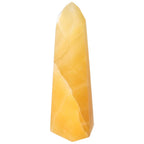 Mexican Calcite Obelisk from Sylvia Crystals, known for enhancing self-confidence and motivation. Handpicked luxury and spiritual tool.
