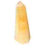 Mexican Calcite Obelisk by Sylvia Crystals, enhancing energy and confidence, ideal for personal growth and positive motivation.
