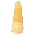 Mexican Calcite Obelisk crystal from Sylvia Crystals, showcasing elegance and spiritual enhancement in its premium design.