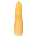 Close-up of a Mexican Calcite Obelisk by Sylvia Crystals, artisan-crafted for enhancing self-confidence and goal achievement.