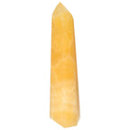 Mexican Calcite Obelisk by Sylvia Crystals, a decorative stone sculpture for enhancing self-confidence and achieving goals.