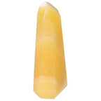 Mexican Calcite Obelisk from Sylvia Crystals, a vibrant tool for motivation and confidence, ideal for enhancing workspace energy.