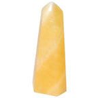 Mexican Calcite Obelisk from Sylvia Crystals, boosts motivation and self-confidence, ideal for home or workspace decor.