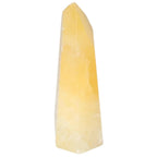 Mexican Calcite Obelisk from Sylvia Crystals, a decorative piece known for positive energy and enhancement of self-confidence.