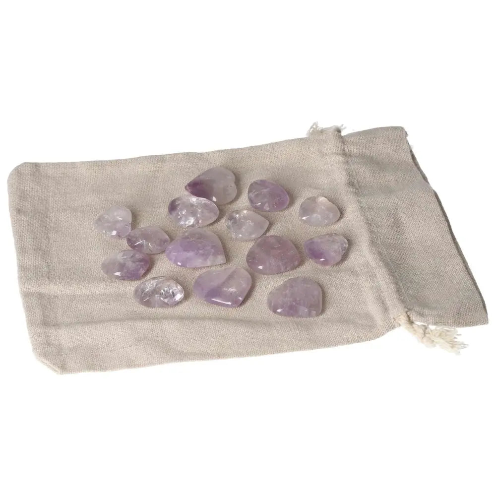 Collection of small amethyst stones on a cloth bag, known for reducing stress, boosting energy, and enhancing emotional stability.