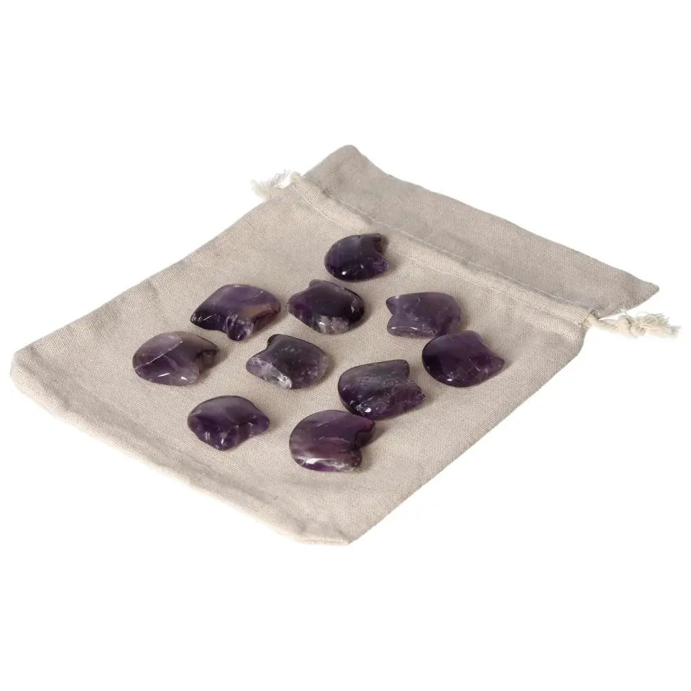 Amethyst crystal stones in a small beige pouch, known for stress relief, energy boost, concentration enhancement, and emotional stability.