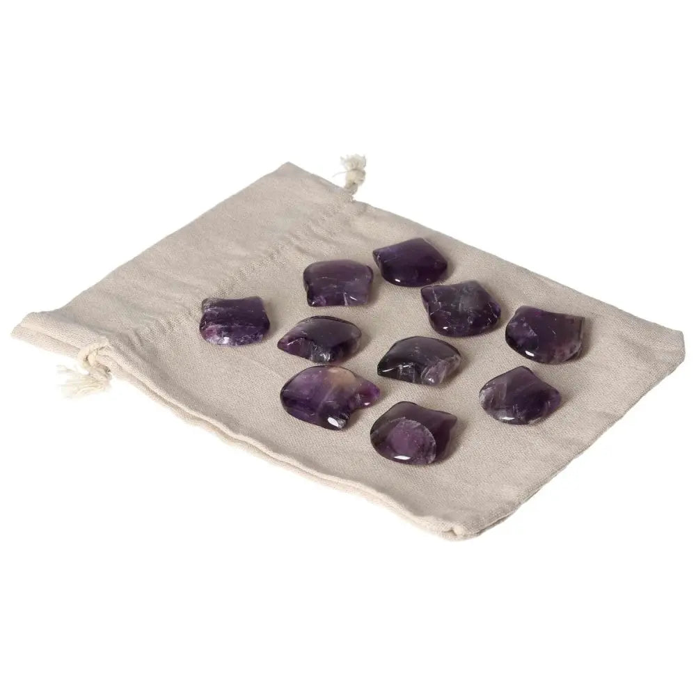 Amethyst small cat stones on beige pouch, enhancing concentration and emotional stability.
