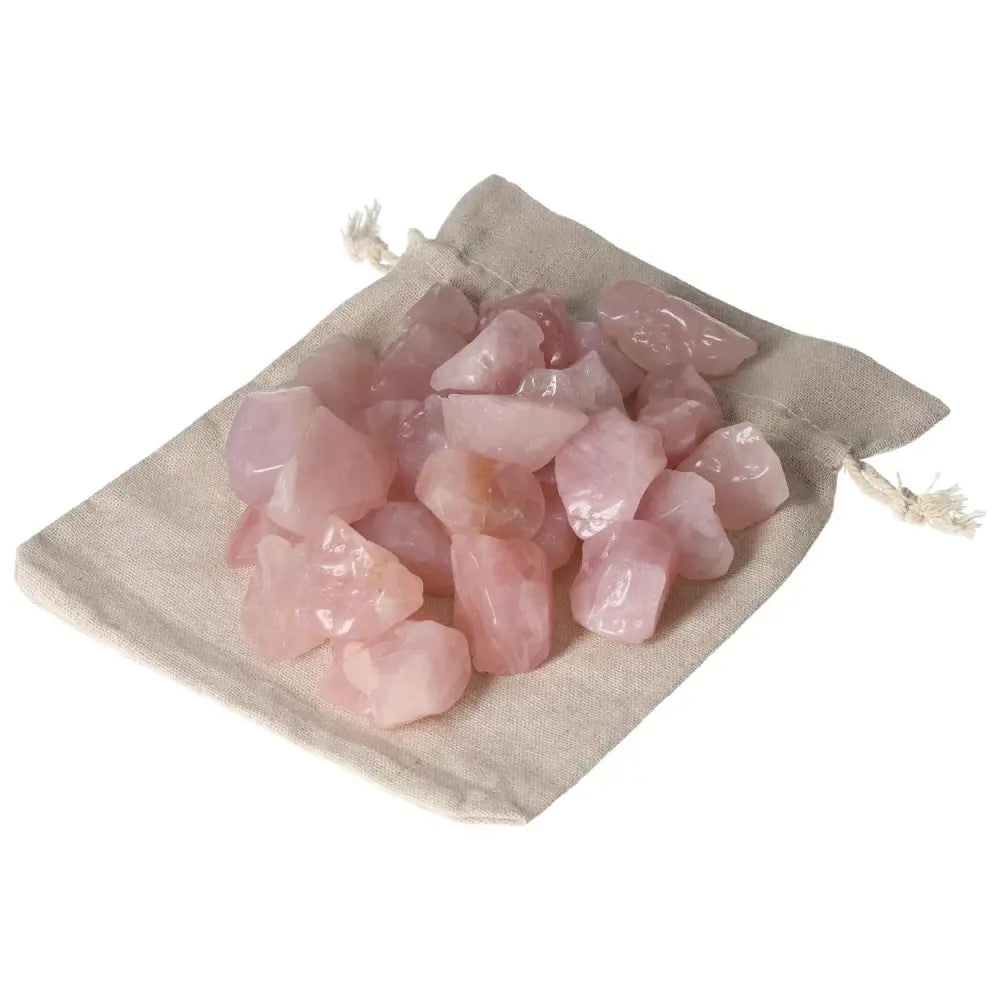 Tumbled Rose Quartz stones in a linen pouch, symbolizing emotional healing and harmony, by Sylvia Crystals.