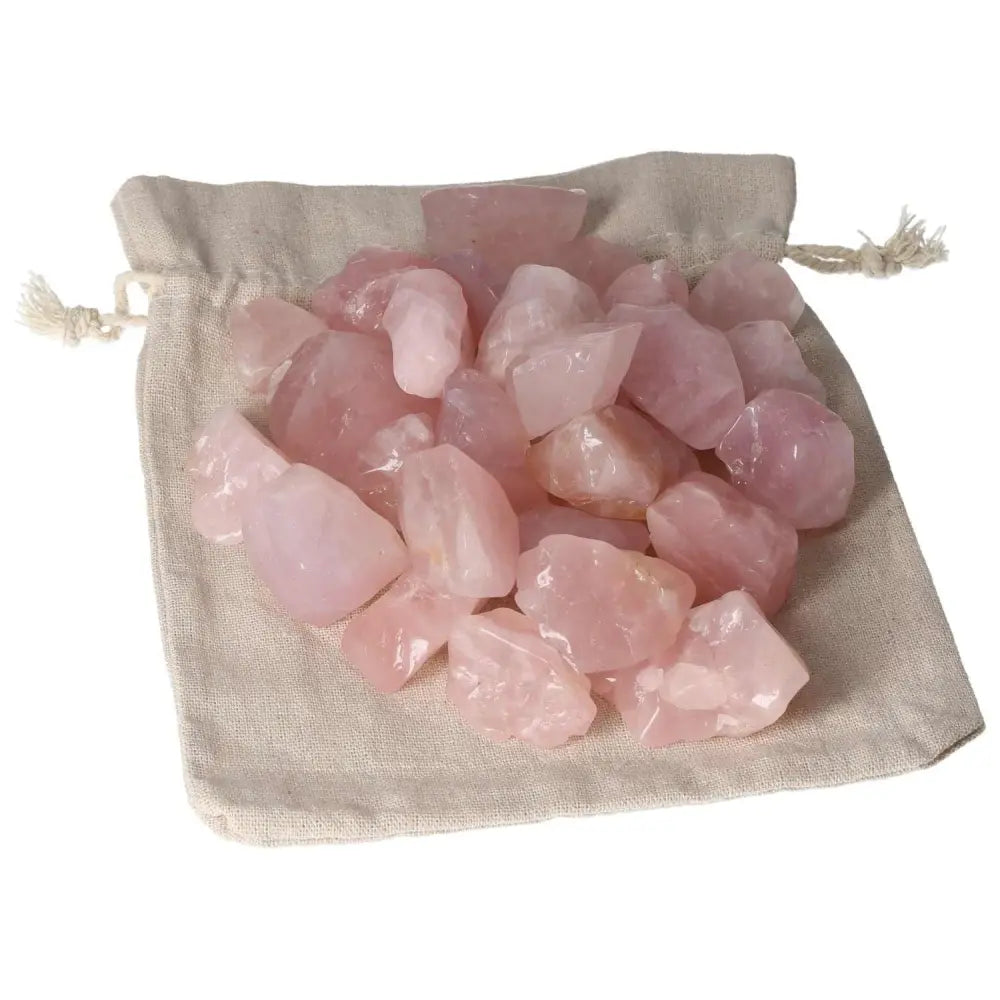 Tumbled Rose Quartz stones on fabric bag from Sylvia Crystals, symbolizing love and emotional healing.
