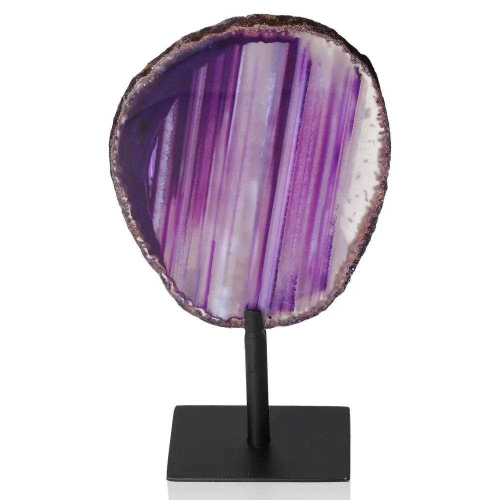 Purple agate slice on black metal stand, showcasing natural bands and textures, enhancing home decor with tranquility and balance.