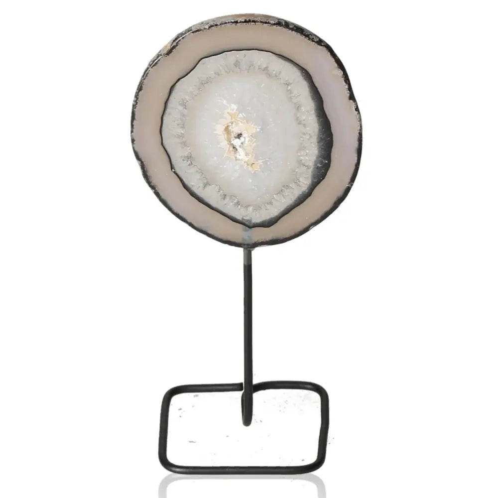 Elegant agate slice on metal stand showcasing unique patterns and hues, ideal for adding sophistication and tranquility to any space.