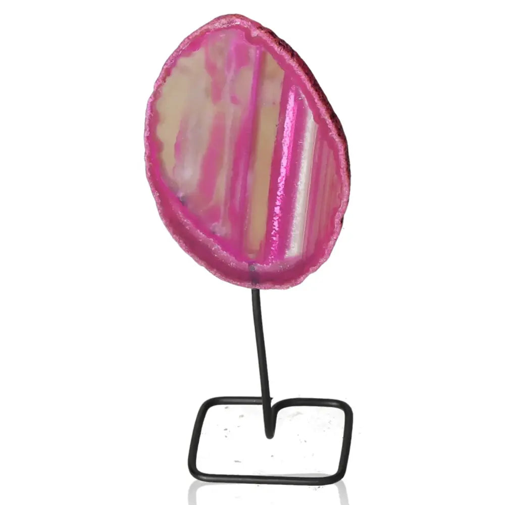 Pink agate slice on metal stand, showcasing unique patterns and vibrant colors for stylish home decor.
