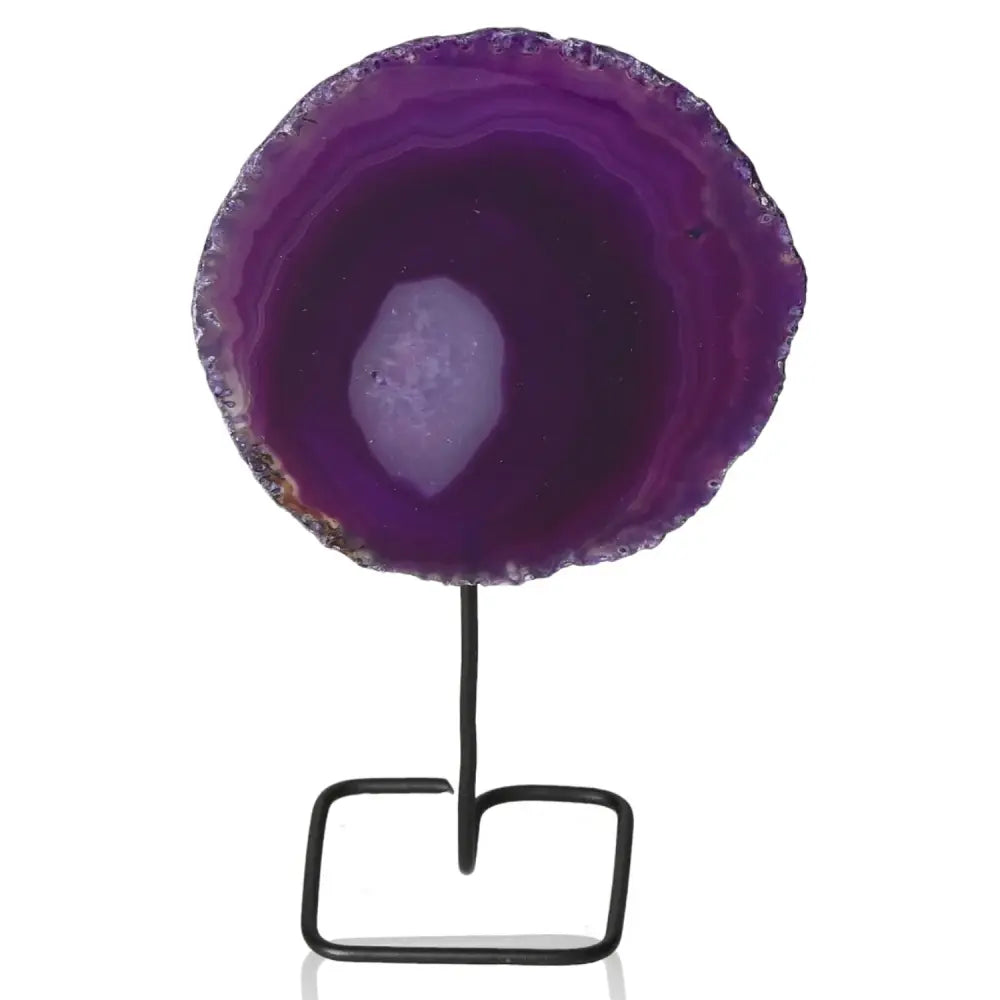 Elegant purple agate slice on black metal stand, showcasing unique vibrant patterns, a sophisticated decorative centerpiece.