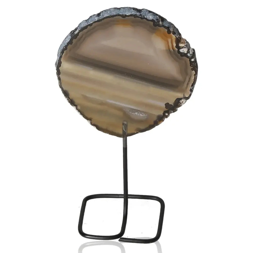 Natural agate slice on sleek metal stand, showcasing vibrant patterns and hues, ideal for adding elegance and tranquility to any decor.