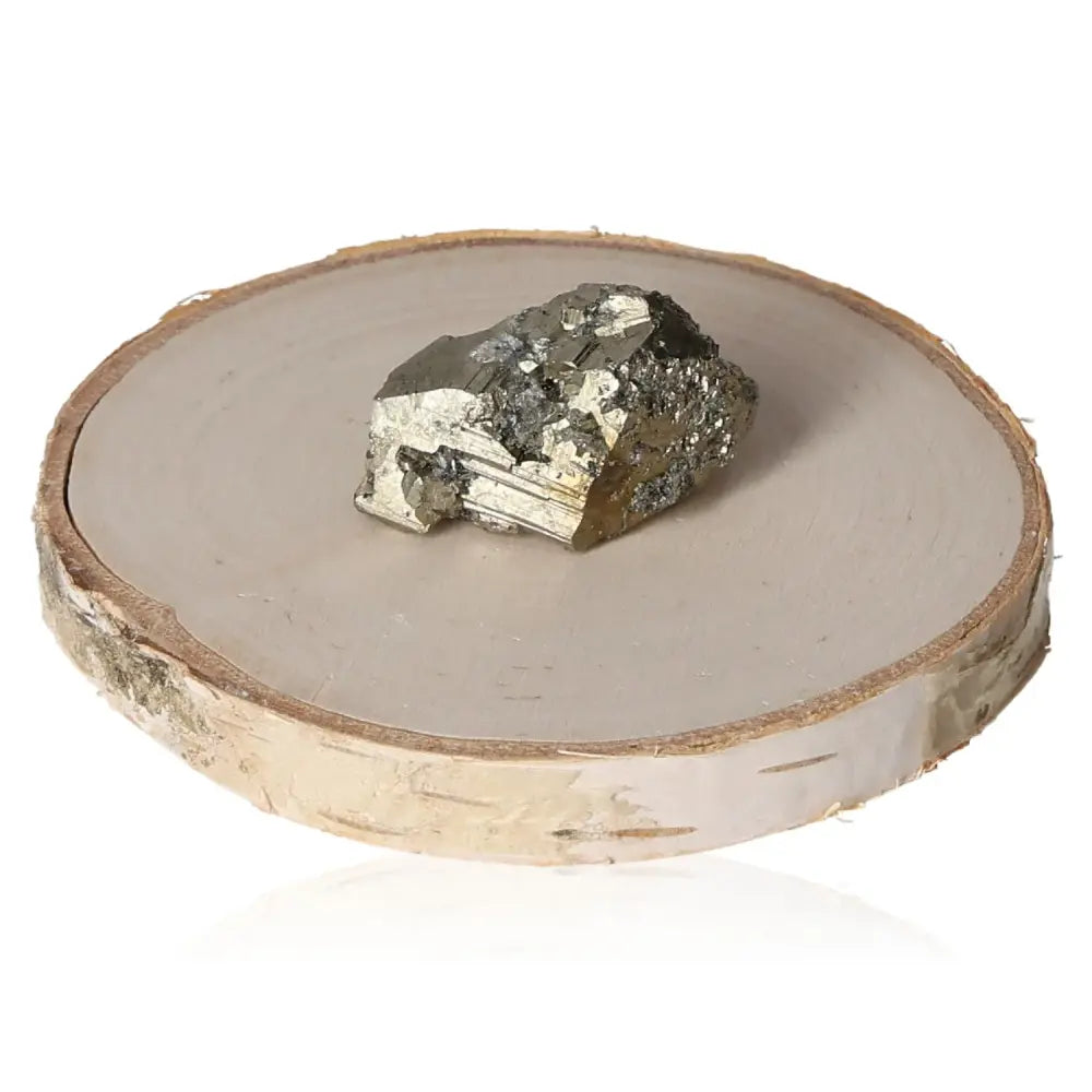 Golden pyrite mineral with metallic luster on a wooden display, symbolizing abundance and prosperity, often called "Fool's Gold."