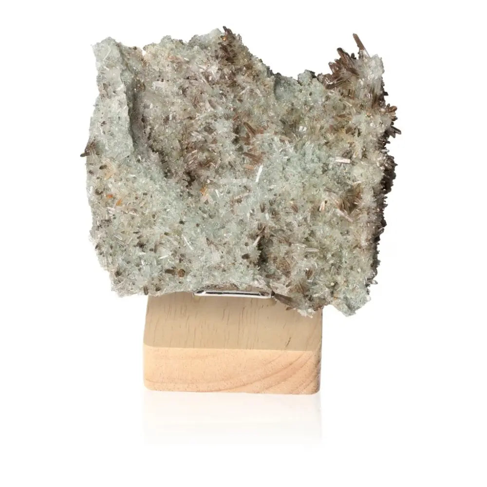 Quartz crystal exhibiting clarity and sparkle, enhancing energy and focus, displayed on a wooden base.