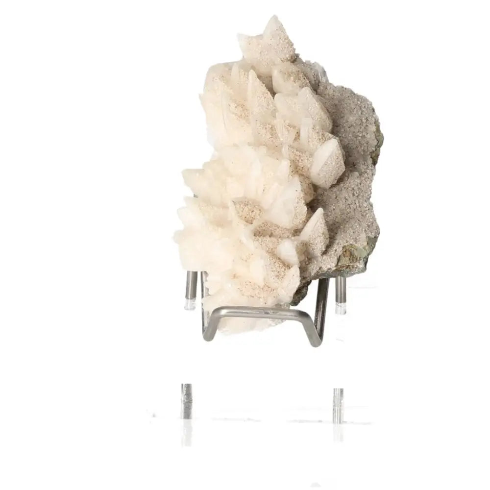 Milky Quartz gemstone with natural cluster formation on a display stand, showcasing its calming energy and spiritual clarity properties.