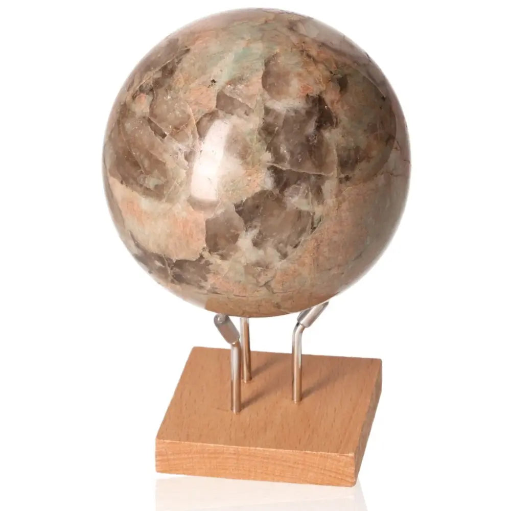 Yellow Moon Stone Sphere on stand, offering the calming benefits of amethyst for stress reduction, energy boost, and emotional balance.