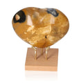 Polychrome Jasper Heart gemstone with vibrant colors on a wooden stand, showcasing earthy tones and unique patterns for grounding energies.
