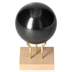 Shungite Sphere 7 cm on stand, crafted by Sylvia Crystals; sleek black finish, protective against electromagnetic frequencies.