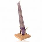 Natural Amethyst Point on wooden stand, showcasing its vibrant purple hues and spiritual connection to the crown chakra.