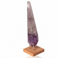 Natural Amethyst Point gemstone on wooden stand, deep purple hues, promotes spiritual enlightenment and chakra balance.