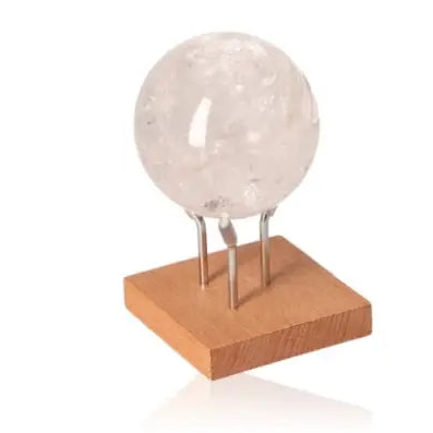 Lemurian Quartz Sphere on wooden stand, showcasing luxury and spirituality in crystal decor by Sylvia Crystals.