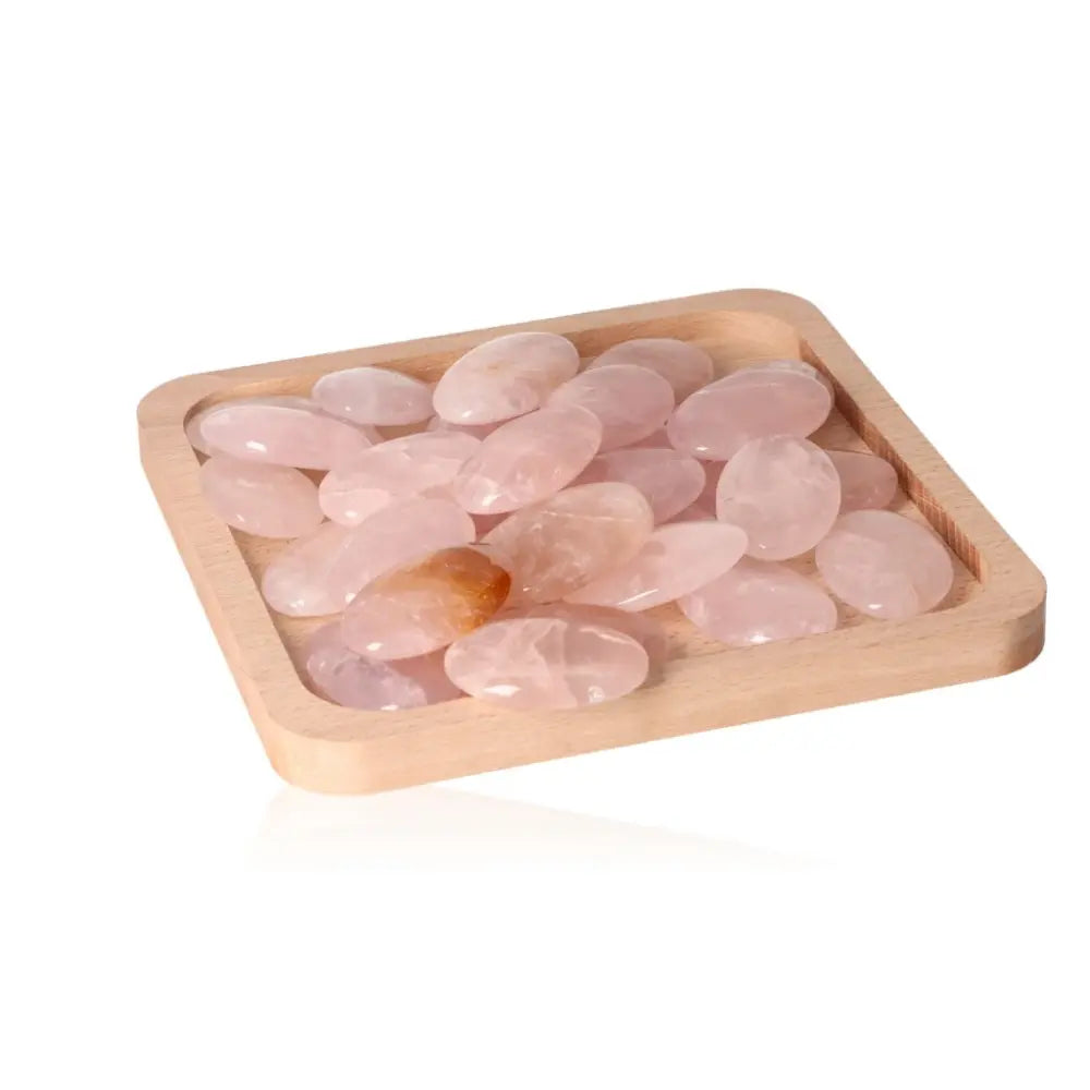 Tray of Rose Quartz Palm Stones from Sylvia Crystals, showcasing natural heart-healing properties and gentle pink hues.