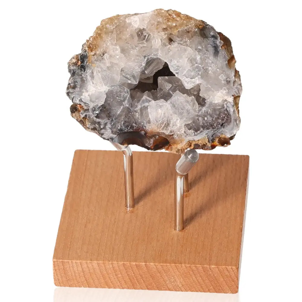 Mini Agate Geode on wooden stand displaying intricate patterns and tranquil colors for energy harmony and emotional stability.