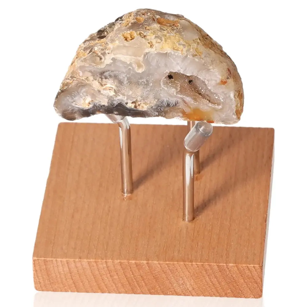 Mini Agate Geode on display stand, showcasing its delicate layers and natural beauty for tranquility and harmonizing ambiance.