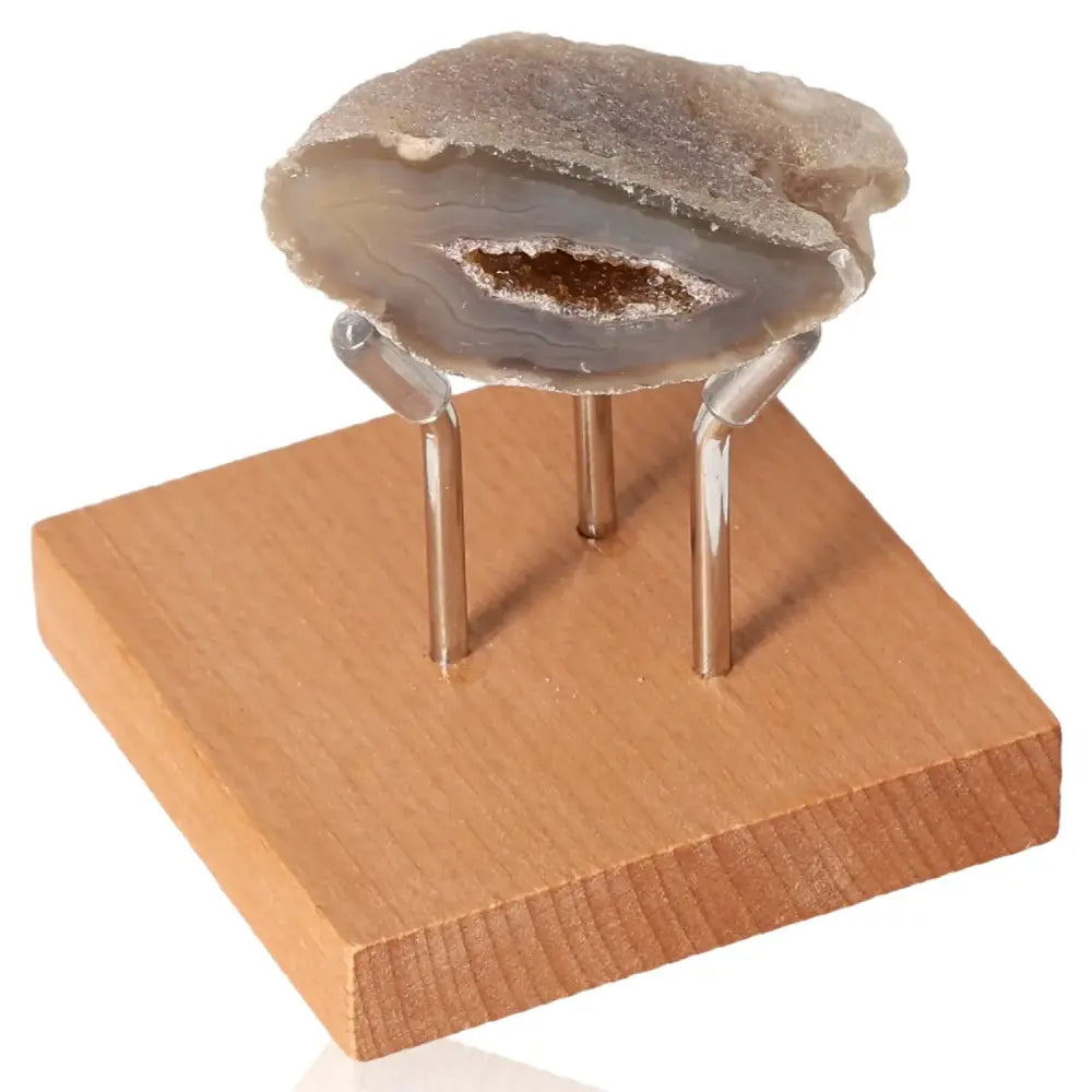 Mini Agate Geode displayed on wooden stand, showcasing its natural beauty and tranquil energy, perfect for home decor and spiritual balance.